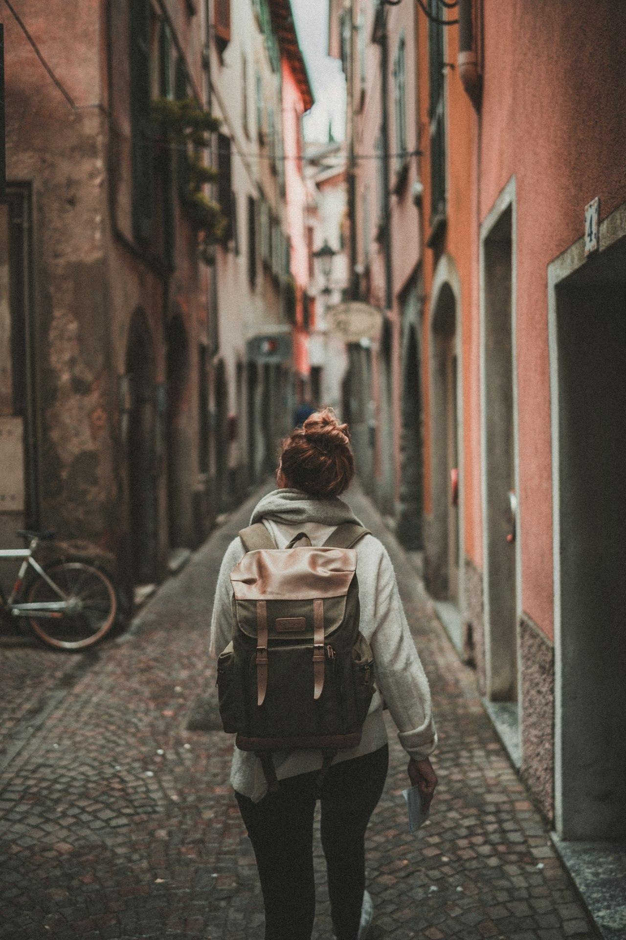 Woman exploring a colorful European alley
